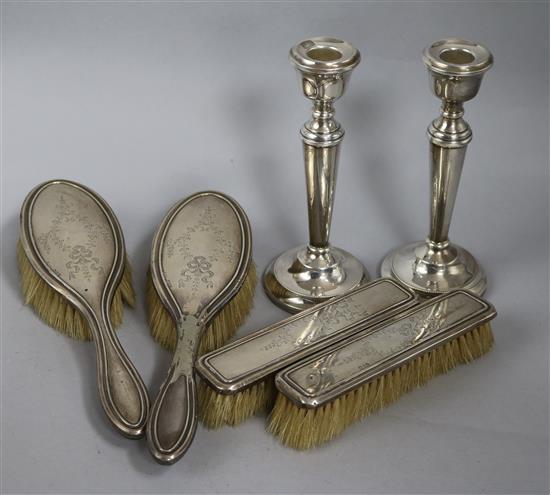 A pair of 1970s silver candlesticks and a silver four piece brush set.